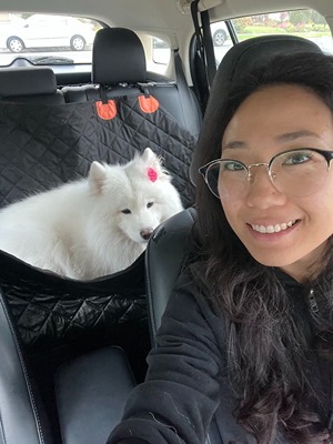 girl with glasses dropping off Samoyed